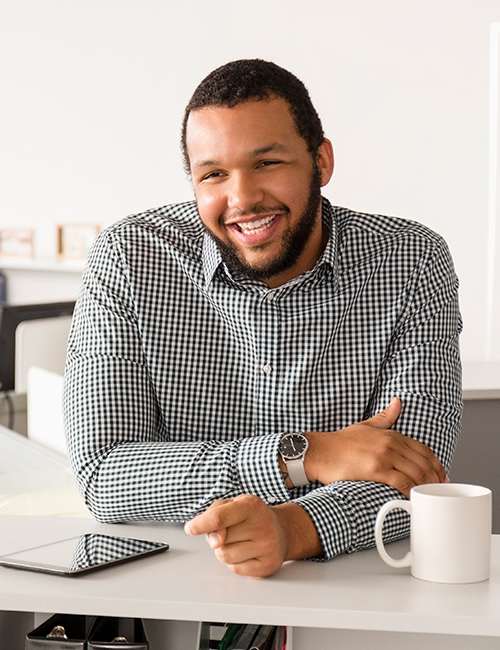 Happy, excited man using laptop